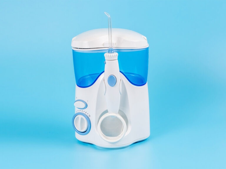 A water flosser on a blue background